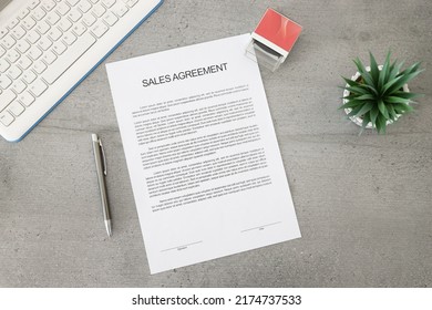 Business document paper of sale agreement. Waiting to sign sales agreements on a desk with a pen, stamp, and plant. Business contract.
