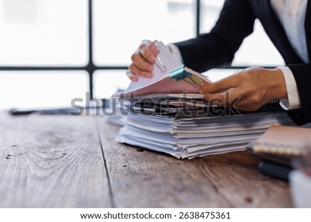 Business Documents, Auditor business checking searching document paperwork or report for analysis TAX Office employee working with documents at workplace desk.
