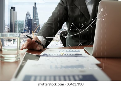  business documents on office table with smart phone and digital tablet and graph business diagram and man working in the background with london city view