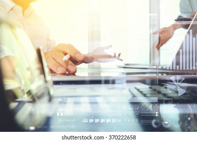 business documents on office table with smart phone and laptop computer and graph finance with social network diagram and two colleagues discussing data in the background - Shutterstock ID 370222658