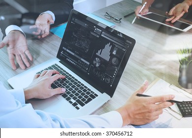business documents on office table with smart phone and laptop computer and graph financial with social network diagram and three colleagues discussing data in the background - Shutterstock ID 370456712