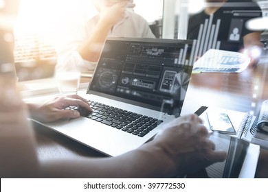 business documents on office table with smart phone and laptop computer and graph finance with social network diagram and three colleagues discussing data in the background - Shutterstock ID 397772530