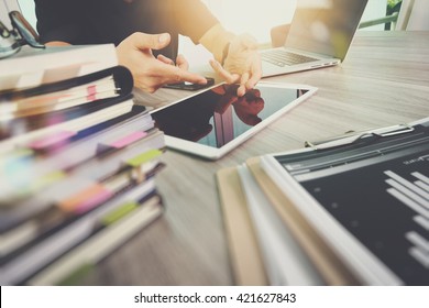 business documents on office table with smart phone and digital tablet and graph finance with social network diagram and man working in the background