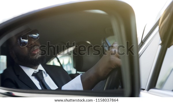 Business driver sitting in auto, wasting time in\
traffic jam, stressful\
life