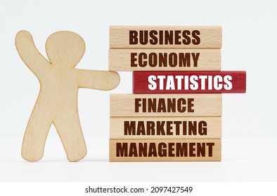 Business and economy concept. On a white background, a wooden man stands and pushes out of the wall a red wooden plate with the inscription - STATISTICS - Powered by Shutterstock - Get 15% off with code: PIKWIZARD15