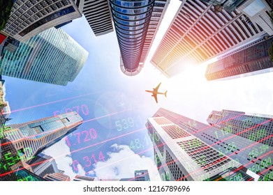 Business Economy Concept Showing Stock Market Ticker On Modern Office Skyscraper Buildings In Singapore's Business And Financial District With Plane Overhead.