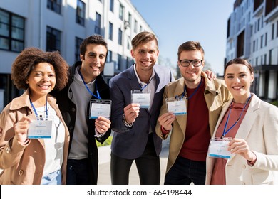 business, education and corporate concept - international group of people with conference badges on city street - Powered by Shutterstock