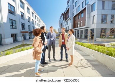 Business, Education And Corporate Concept - International Group Of People With Conference Badges On City Street