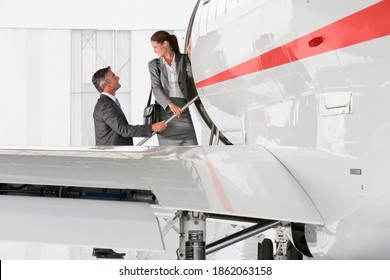 Business Employees Getting On A Private Jet