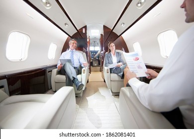 Business Employees Having A Meeting While Sitting In A Private Jet