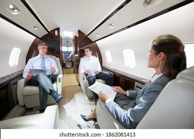 Business Employees Having A Meeting While Sitting In A Private Jet