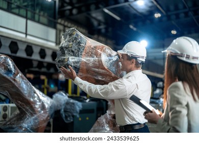 Business engineers meeting and checking new machine robot. Workers walking at warehouse industry welding machine. business negotiation concepts and technology. women Using smart Tablet to present man. - Powered by Shutterstock