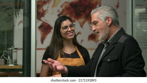 Business Entrepreneur Talking With Coffee Shop Employee. Older Male Manager Explaining Store To Young Female Worker