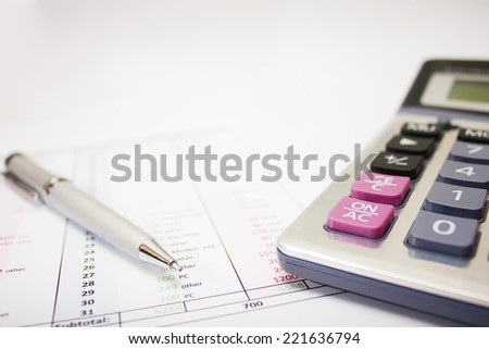 business environment. gray ballpoint pen, printed document and a large calculator on the table. Closeup.