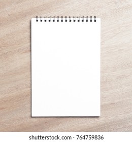 Business Essentials. Top View Of Spiral Blank Notebook On Wood Desk Background