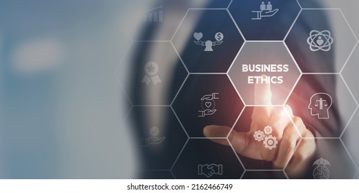 Business ethics concept. Ethical investment, sustianable development. Business integrity and moral. Businessman touching on BUSSINESS ETHICS wording on smart screening surrounded by ethical elements. - Shutterstock ID 2162466749