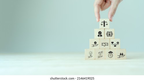 Business ethics concept. Ethical mindset. Business integrity and moral. Putting wooden cubes with ethics icon standing with other ethics icon. Company culture and sustainable success - Shutterstock ID 2146419025