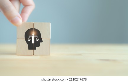 Business ethics concept. Ethics inside human mind. Business integrity and moral. The wooden cubes with ethics inside a head symbols on grey background and copy space. Company ethics culture. ESG.