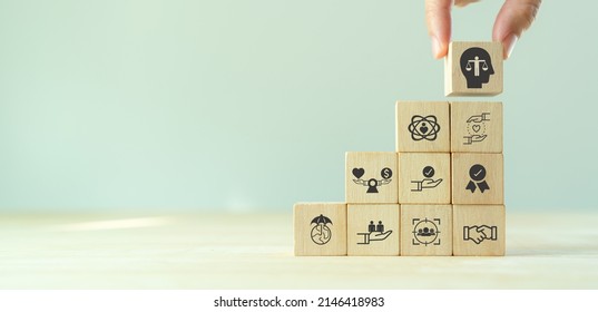 Business ethics concept. Ethics inside human mind. Business integrity and moral. Putting wooden cubes with ethics inside a head standing with other ethics icon. Company culture and sustainable success - Shutterstock ID 2146418983