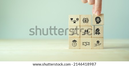 Business ethics concept. Ethics inside human mind. Business integrity and moral. Putting wooden cubes with ethics inside a head standing with other ethics icon. Company culture and sustainable success