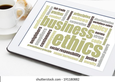 business ethics word cloud on a digital tablet with a cup of coffee