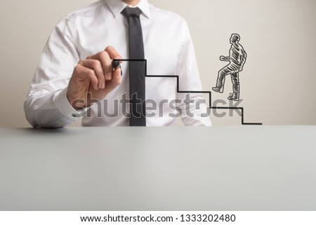 Business executive drawing steps for a handdrawn businessman to climb in a conceptual image. With copy space.