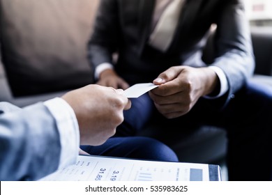 business executive exchanging business card - Powered by Shutterstock