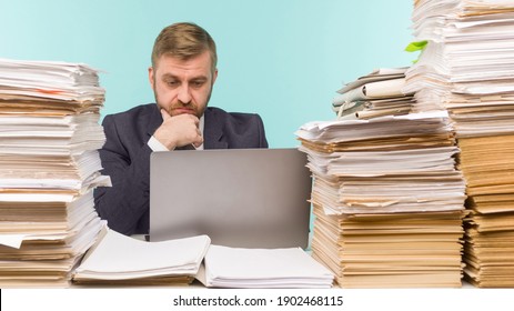 Business executive holds a video conference in the office and piles of paperwork, he is overloaded with work 