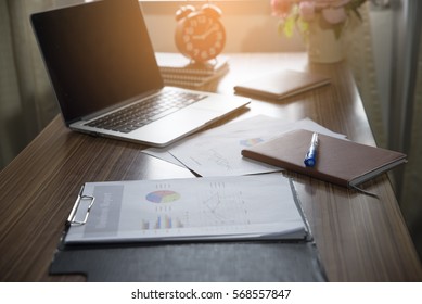 Business executive home Desk  office Background concept. Business computer empty home office table with desktop laptop, notebook, clock, pen, diary book, annual, summary report, document, and paper