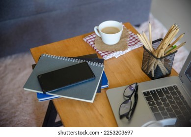 Business executive home office Desk Background concept. Business computer empty home office table with desktop laptop, notebook, smartphone, diary book, cup of coffee, pencil, document, and glasses.