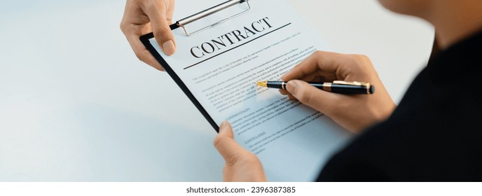 Business executive signing contract agreement document on the bale with the help from company attorney or lawyer service in law firm office. Business investing and finalizing legal processing. Shrewd - Shutterstock ID 2396387385