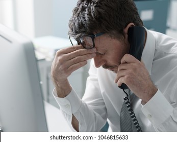 Business Executive Working In The Office And Receiving Bad News On The Phone, Failure And Crisis Concept