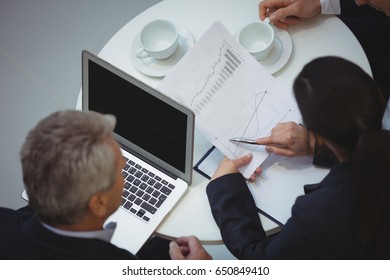 Business executives analyzing reports at office - Shutterstock ID 650849410