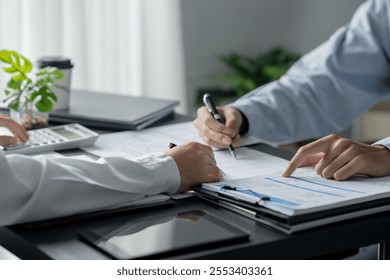 Business executives discussing with data spreadsheets evaluating on investment 