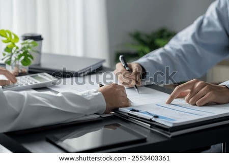 Business executives discussing with data spreadsheets evaluating on investment 