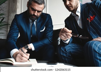 Business executives discussing work, developing strategy for online business, explaining sharing ideas, preparing presentation, having brainstorming session at office.