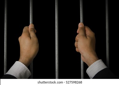 Business executives to prison with a dark background.Looking at the freedom within the prison.