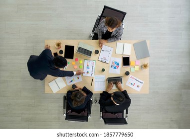 Business Executives Team Meeting 2021 Business Plan In Modern Office With Laptop Computer, Coffee And Document On Table. People Corporate Business Team Concept. Top View