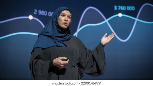 Business Expo Stage: Famous Inspirational Speaker From Gulf Region Talking about Technology, Science, Success, Productivity. Tech Industry Businesswoman in Traditional Arab Hijab Giving a Presentation - Powered by Shutterstock