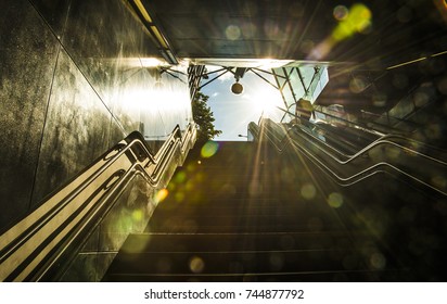 Business fat man with baggage in the terminal modern window background with sunset orange tone ,with blank copy space.Urban man on an escalator rises up to meet the morning rays of the sun - Powered by Shutterstock