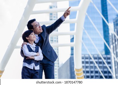 Business father showing heritage of property to his son that young boy will be heir. Little child is inheritor of property in the future. Businessman pointing finger to his property for showing son - Shutterstock ID 1870147780