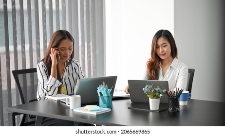 Business Female Manger Talking With Business Potential Partners While Her Colleague Working On Laptop Computer.