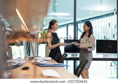 business female worker working on laptop computer. Portrait confident asian women smiling looking at camera at modern smallbusiness home office