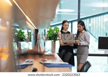 business female worker working on laptop computer. Portrait confident asian women smiling looking at camera at modern smallbusiness home office