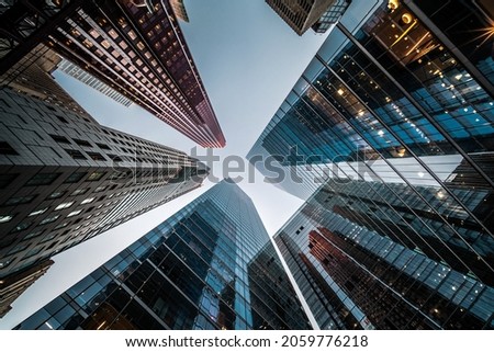 Business and finance concept, looking up at high rise office building architecture in the financial district of a modern metropolis.
