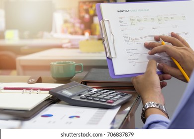 Business And Finance Concept Of Office Working, Businessman Discussing Monthly Sales Forecast Analysis Chart And Using Calculator For Calculate Result, Vintage Effect