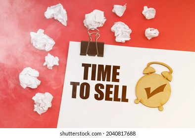 Business And Finance Concept. On A Red Background In Smoke, Crumpled Paper And A Sheet With The Inscription -TIME TO SELL