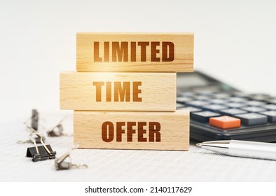 Business And Finance Concept. On The Reports Is A Pen, Calculator, Clips And Wooden Boards With The Inscription - Limited Time Offer