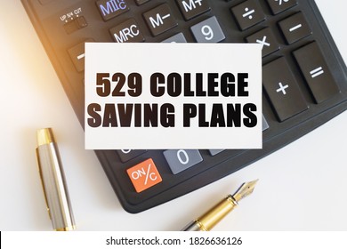 Business And Finance Concept. On The Table There Is A Pen, A Calculator And A Business Card On Which The Text Is Written - 529 COLLEGE SAVING PLANS