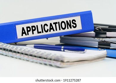 Business and finance concept. On the table are a notebook, a pen, documents and a folder with the inscription - APPLICATIONS - Shutterstock ID 1911275287